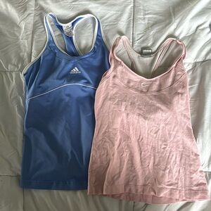 Women’s medium pink Nike and blue Adidas athletic tank tops.